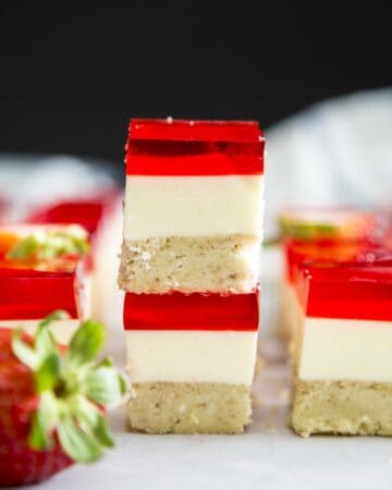 A stack of two Strawberry Jello cream cheese dessert squares.