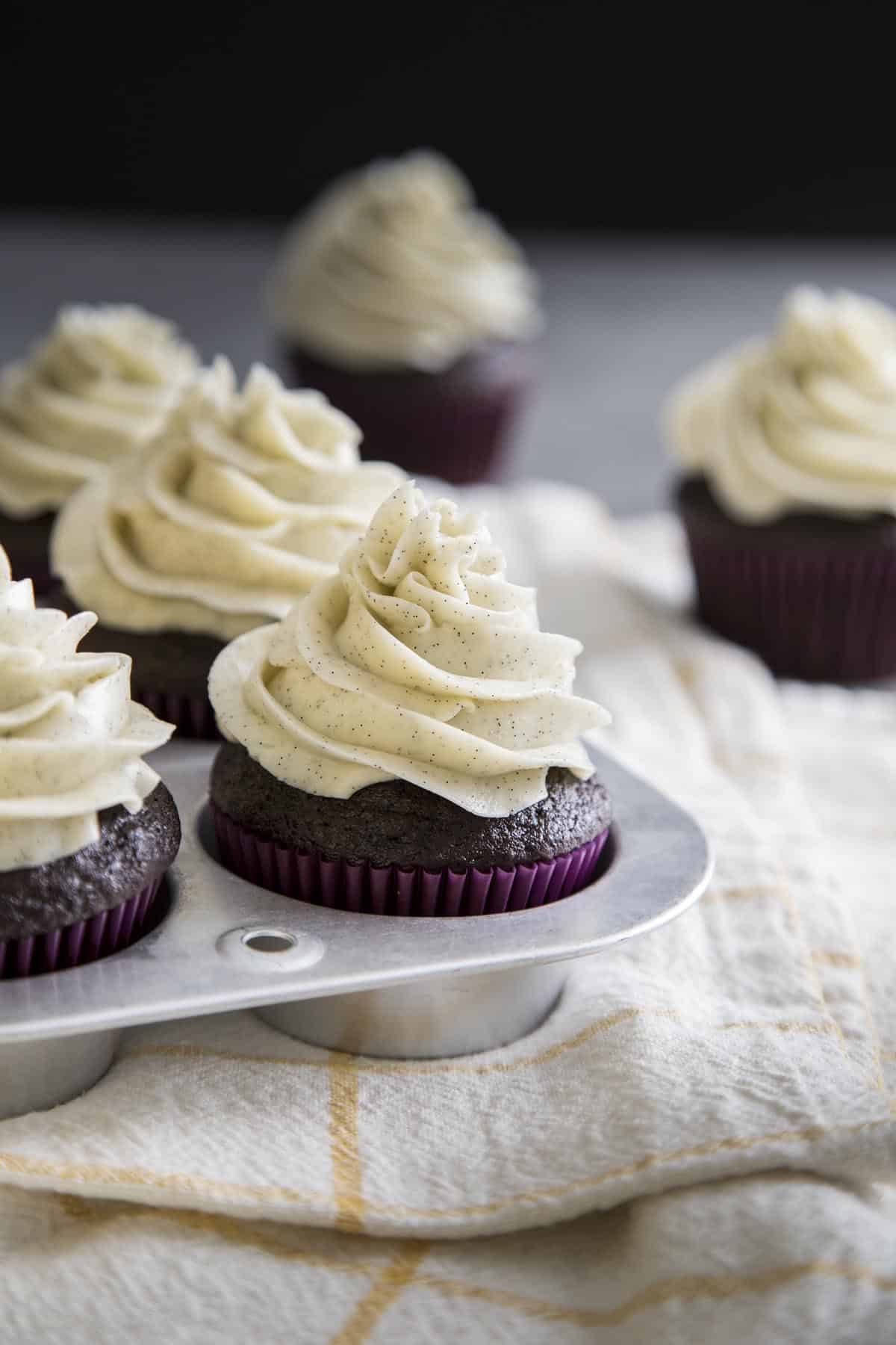 Chocolate Cupcakes with vanilla bean swiss meringue buttercream in a muffin pan