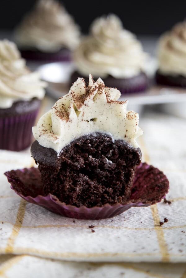 Chocolate cupcake with a bite taken out.