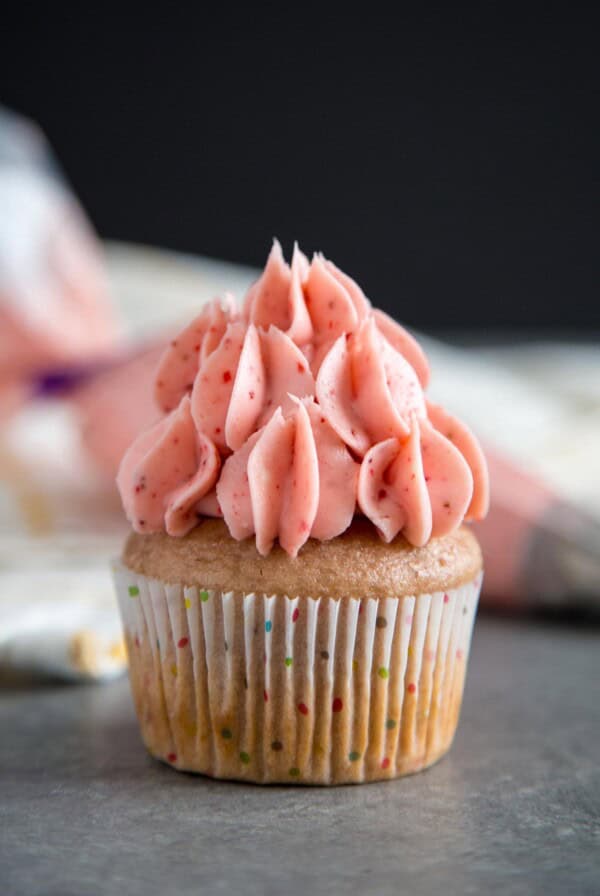 Strawberry Cream Cheese Frosting on top of a cupcake.