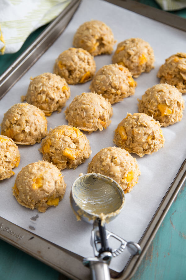 Tropical Mango Oatmeal Cookie dough balls on a baking sheet