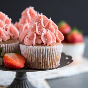 Strawberry cupcakes on a cake stand.
