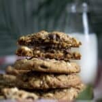 A stack of Hawaiian Island Cookies with the top one broken in half showing the inside.
