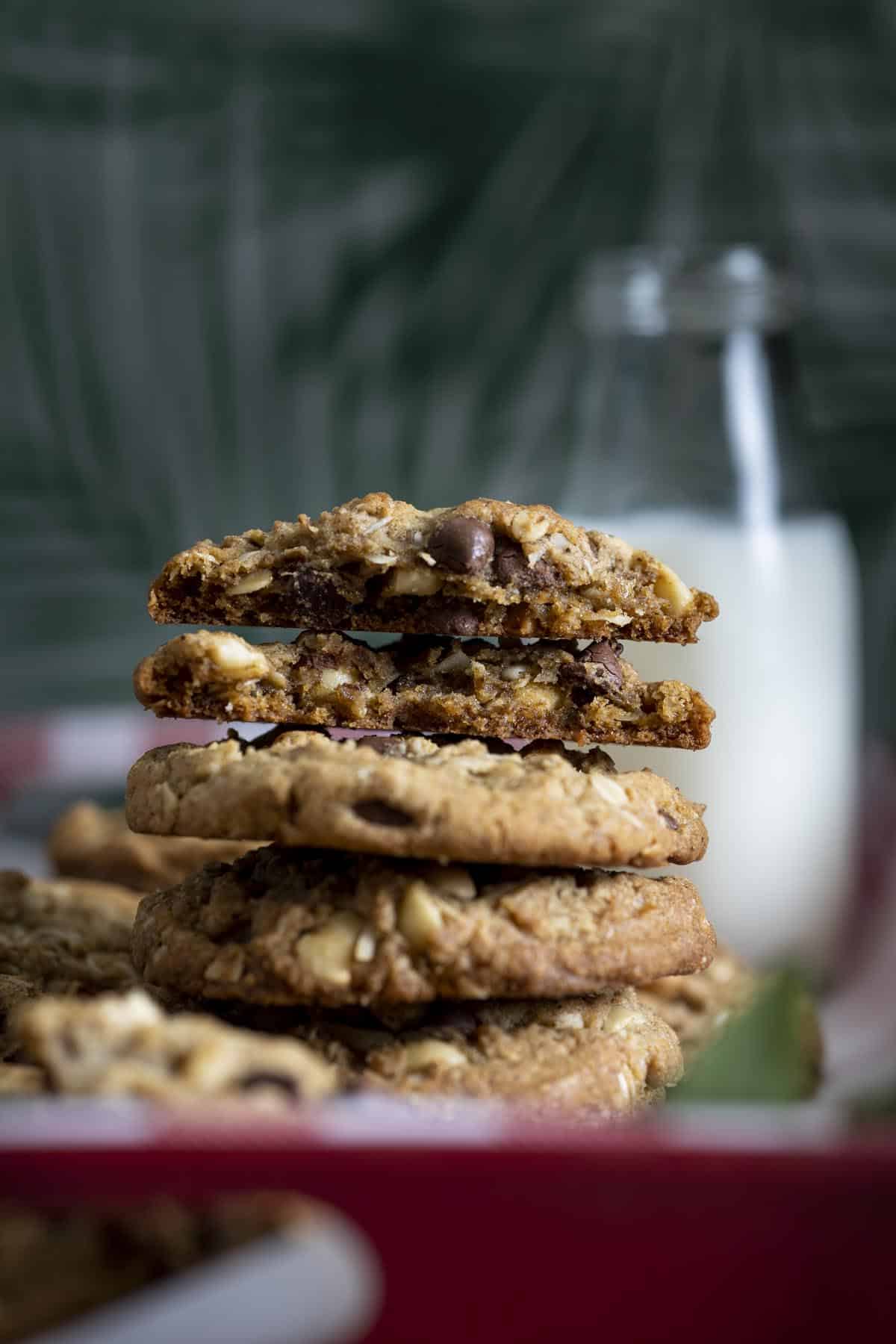 A stack of Hawaiian Kitchen Sink Cookies with the top one broken in half showing the inside.