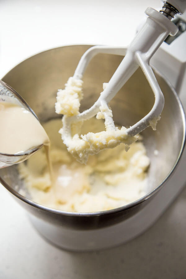 Pouring buttermilk and egg mixture into the creamed butter