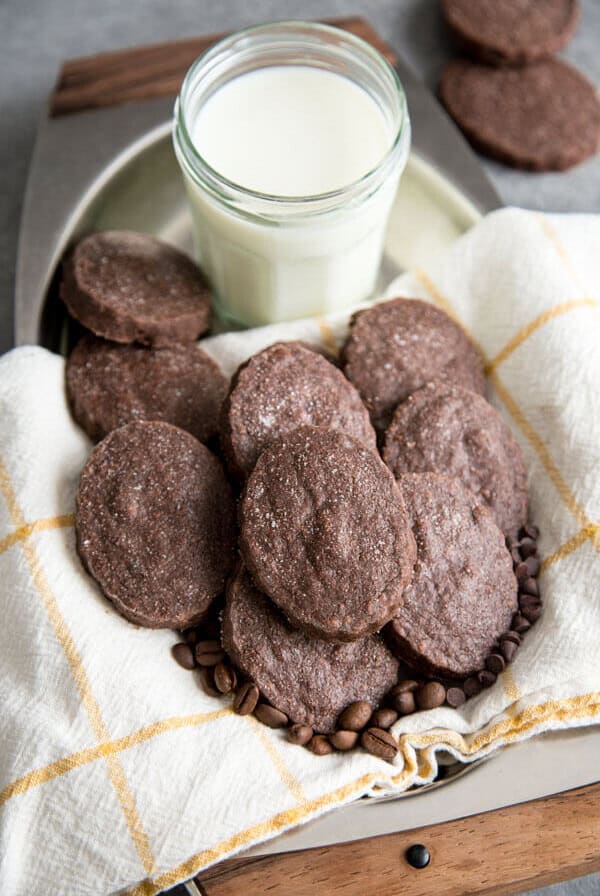 Chocolate Espresso Shortbread Cookies on a serving tray next to a glass of milk