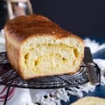 Sliced open Coconut Bread on a wire rack.