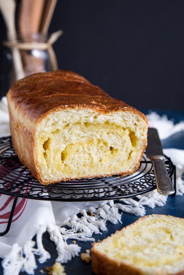 Sliced open Coconut Bread on a wire rack.