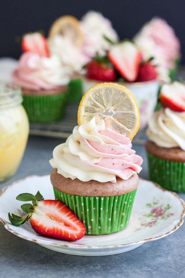 Strawberry lemonade cupcake decorated with a candied lemon slice on a plate