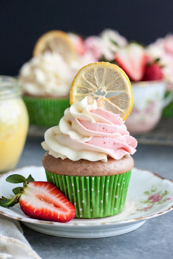 Strawberry lemonade cupcake decorated with a candied lemon slice on a plate