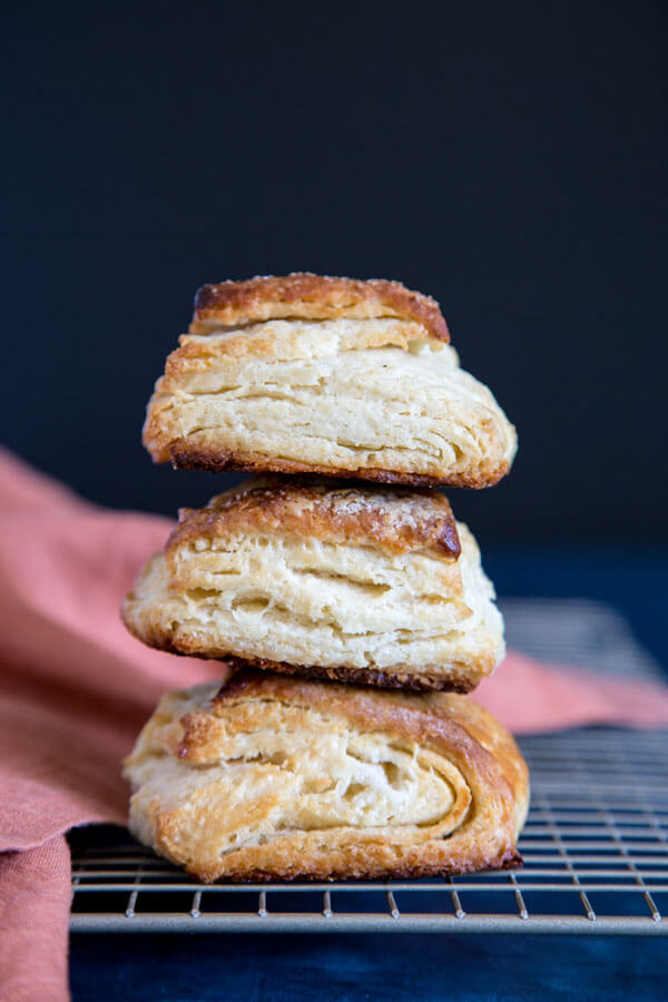 A stack of 3 honey buttermilk biscuits on a wire rack