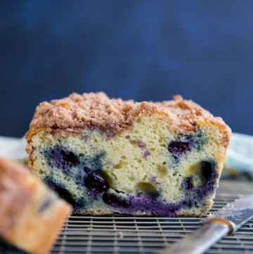 A cross-section photo of a Blueberry coffee cake on a wire rack