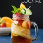 A glass of Pimm's Cup cocktail with colorful garnishing.