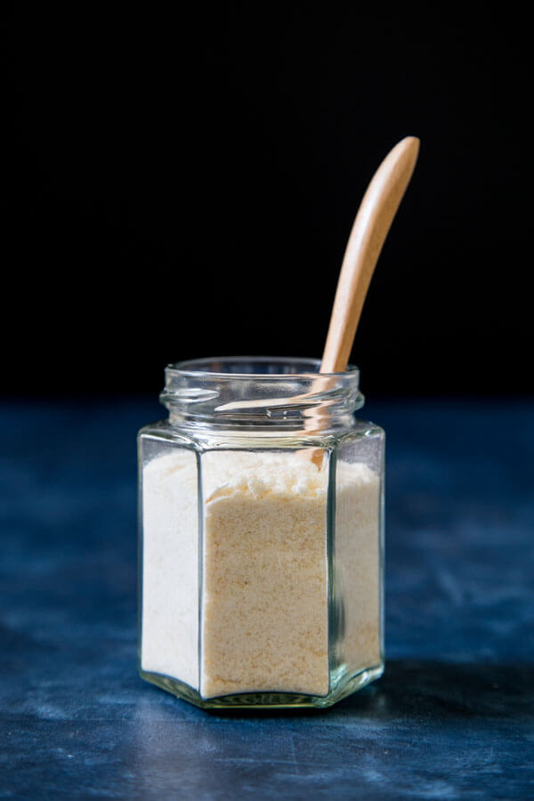 Caramelized sugar dust in a jar with a small wooden spoon