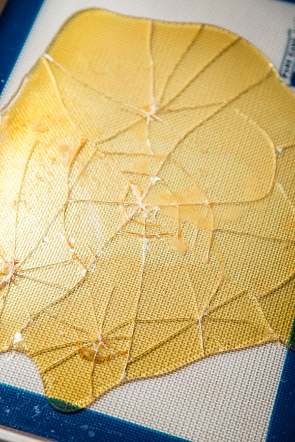 Hardened caramelized sugar on a baking sheet broken into shards