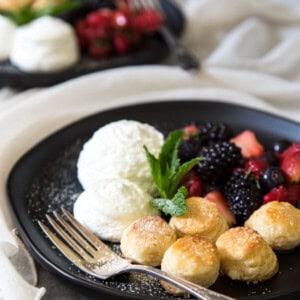 Mixed berry shortcake on a plate, garnished with mint leaves