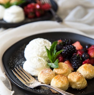 Mixed berry shortcake on a plate, garnished with mint leaves