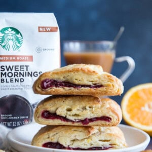A stack of three cranberry orange scones on a plate