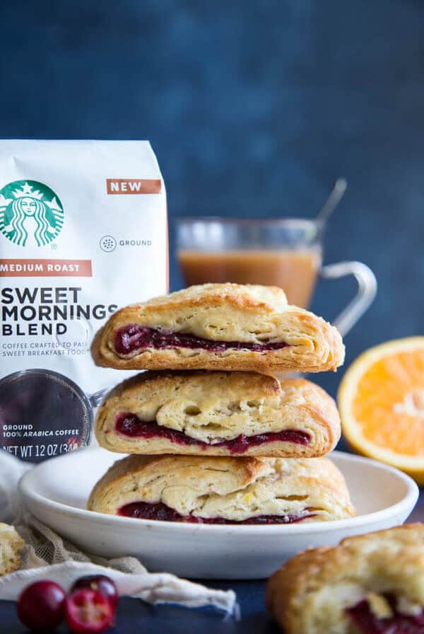 A stack of three cranberry orange scones on a plate