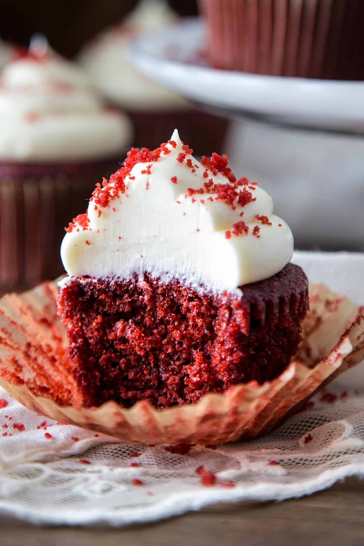 Cream cheese frosting on a red velvet cupcake.