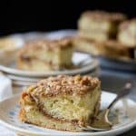 A slice of sour cream coffee cake on a plate