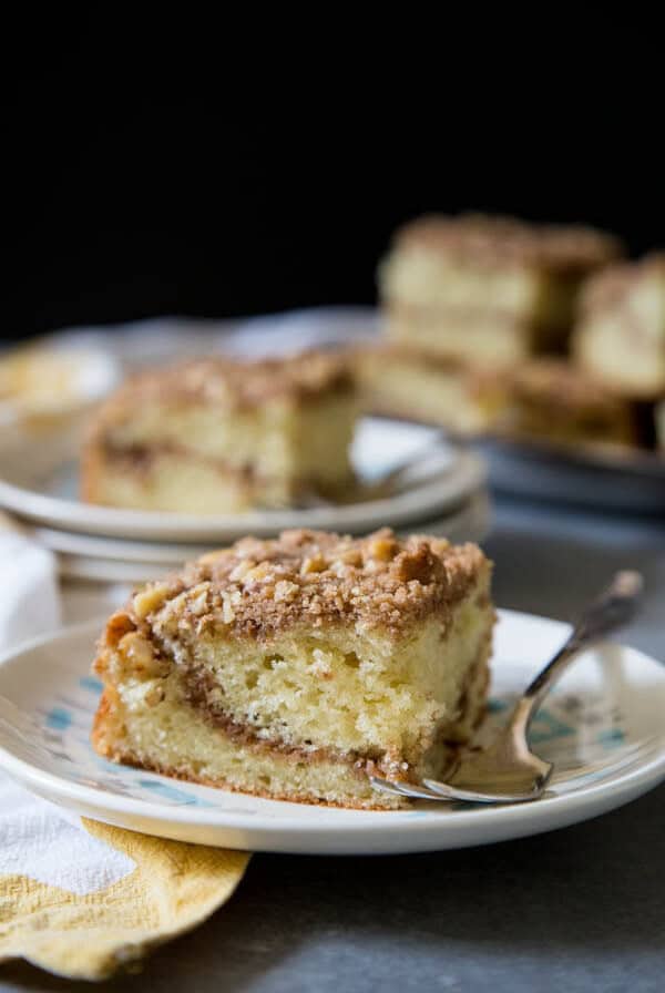 A slice of sour cream coffee cake on a plate
