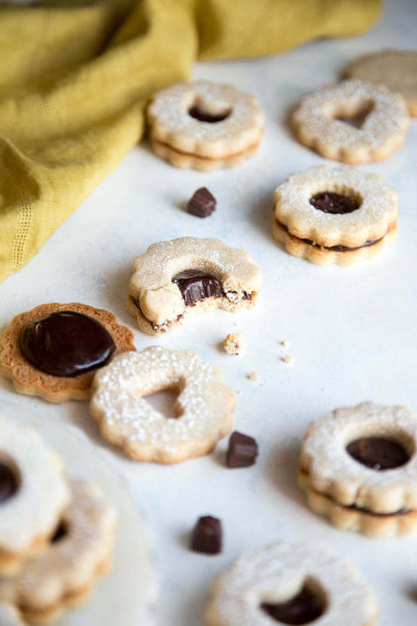 Chocolate ganache linzer cookies on table surface