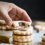 A stack of chocolate ganache linzer cookies