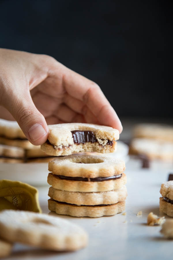 A stack of chocolate ganache linzer cookies