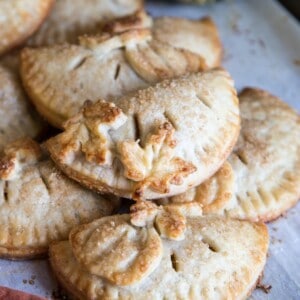 Pumpkin hand pies on a baking tray.