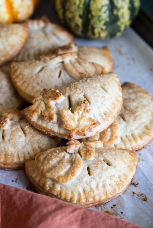 Pumpkin hand pies on a baking tray.
