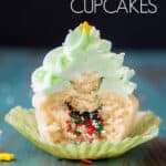 Half a piñata cupcake with sprinkles spilling out from the middle.