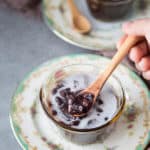 Che dau den with coconut milk in a small bowl