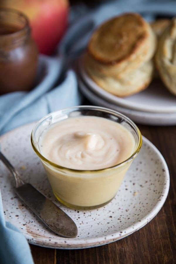 Honey butter in a small glass bowl on a plate