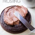 Adding chocolate buttercream on chocolate cake.