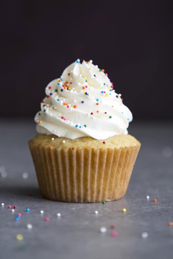 Vanilla buttercream frosting on top a cupcake.