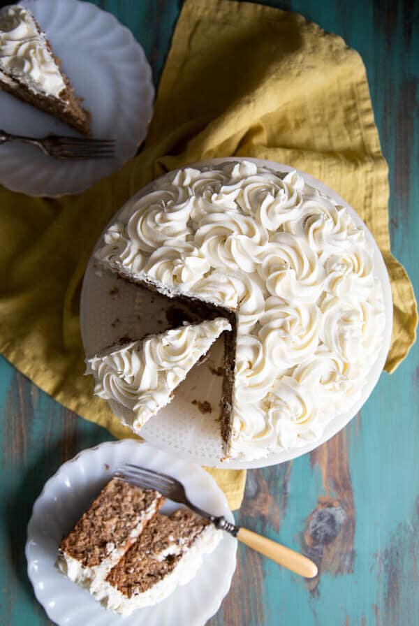 Hummingbird cake on a cake stand and slices on plates
