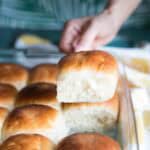 Serving a Samoan coconut bun from the tray.