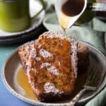 Pouring maple syrup over banana bread french toast.