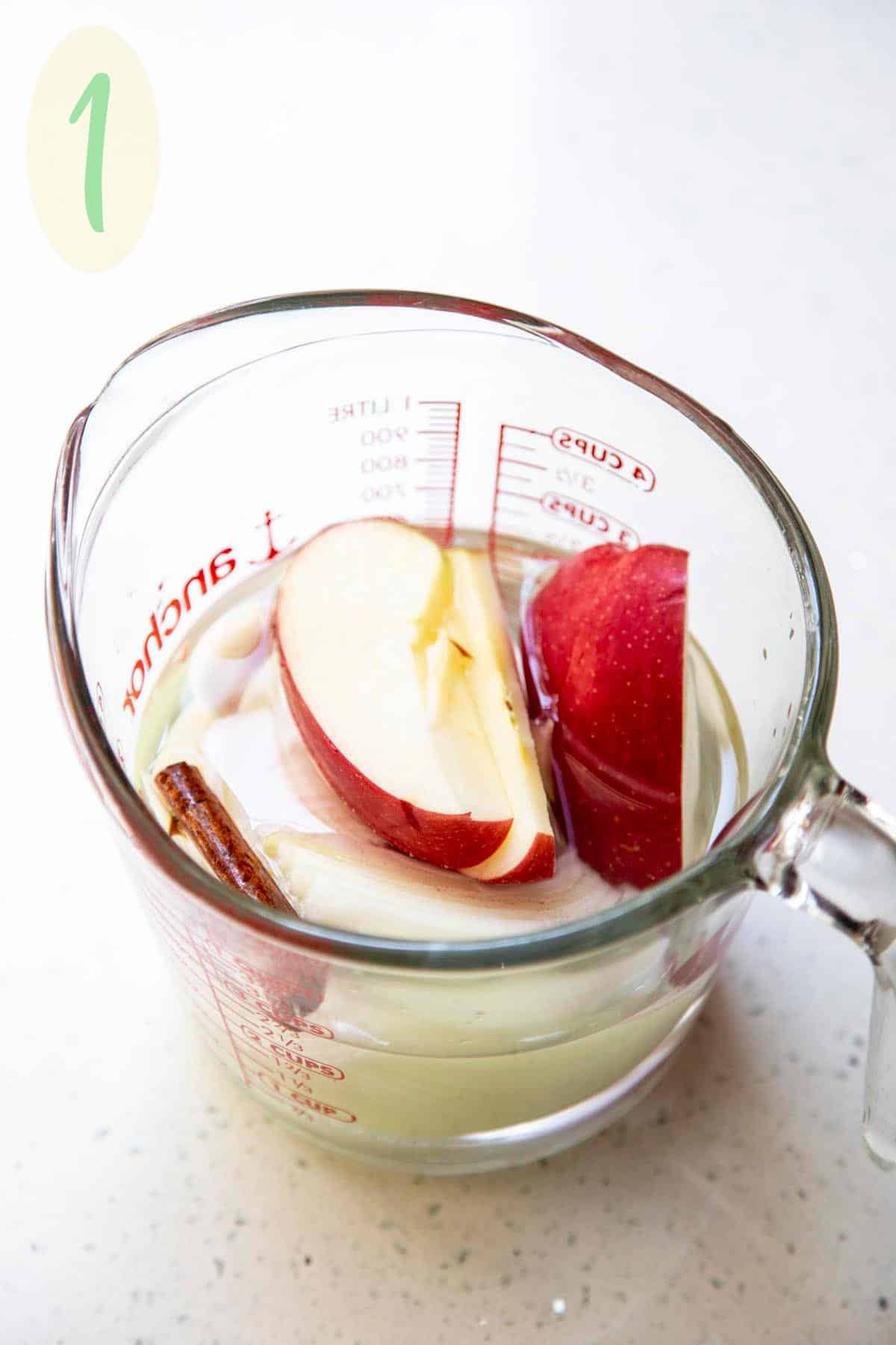 Ryan’s Thanksgiving Roast Turkey has been keeping our family full and happy for almost 10 years! This year we decided to share this recipe with you because it really is a tried and true recipe to keep for generations. #wildwildwhisk #thanksgiving #thanksgivingturkey #roastturkey #roastturkeyrecipe Apple, onion, cinnamon, garlic in water in a pyrex measuring cup