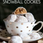 A tea cup full of macadamia snowball cookies.