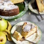 A slice of almond pear cake on a plate with a fork