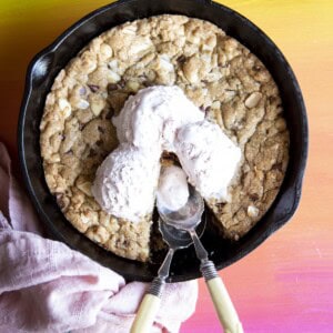 Overhead view of a pizookie in a skillet with ice cream on top