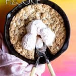 A pizookie in a cast iron skillet with 3 scoops of ice cream on top