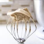 Peanut butter frosting on a wire whip.