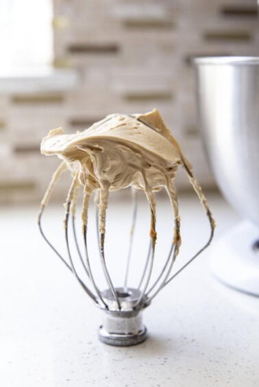 Peanut butter frosting on a wire whip.