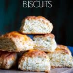 A stack of cheese biscuits on a wooden board.