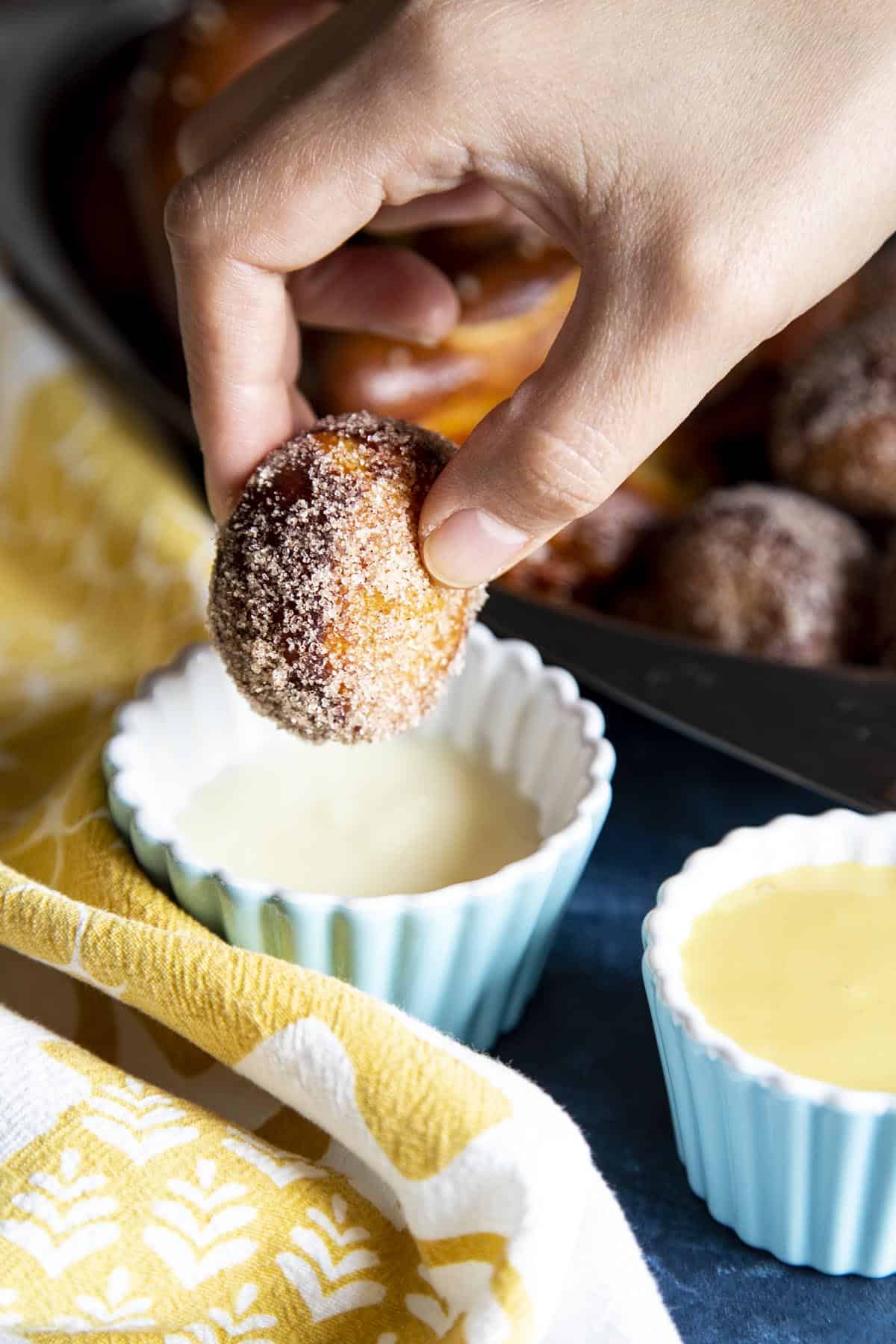 Soft Pretzels and Pretzel Bites Dipping a cinnamon sugar pretzel bite into a cup of sweet cream cheese sauce.