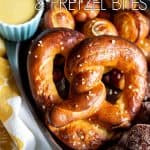 A pretzel in a tray with pretzel bites at the bottom.