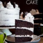 A slice of 3-layer Oreo cake on a plate.